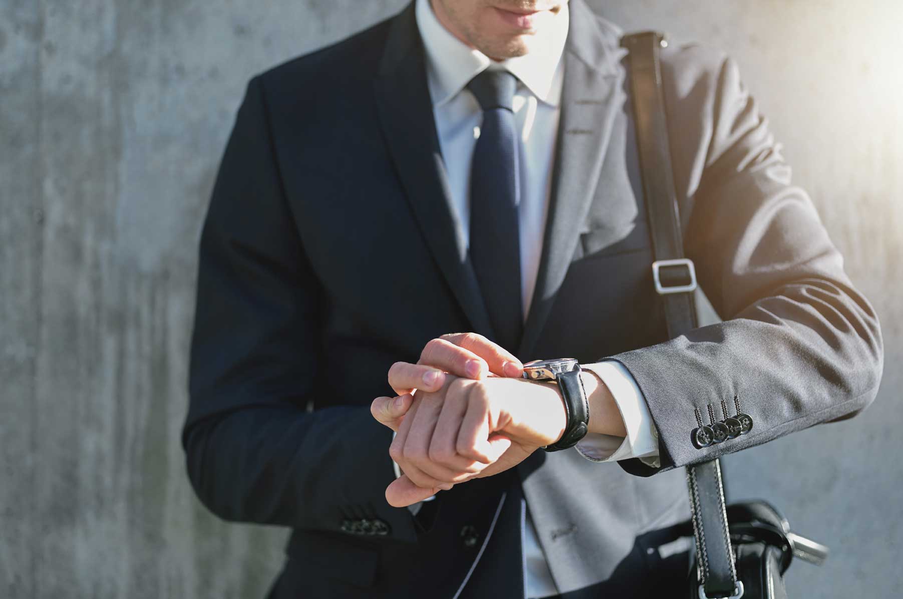 stylish-man-wearing-suit-looks-at-watch-N9PEHC7 | Siren Design
